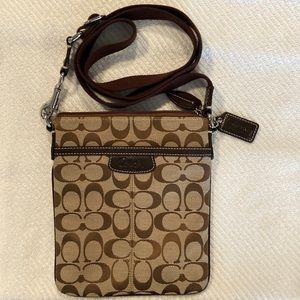 Coach cross body bag.  Brown with signature logo.  Measures 7 1/2 x 8 1/2.